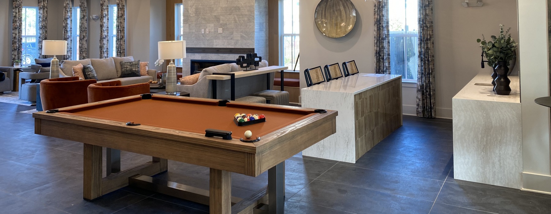 Resident gathering spaces with fireplace and pool table at Riverchase Vista Savannah apartments.