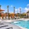 Expansive pool deck area with lounging chairs and umbrellas 