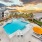 Expansive pool deck area with lounging chairs and umbrellas 