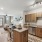 Spacious kitchen and living room area with stainless steel appliances