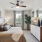 Bedroom with ceiling fan and natural light 