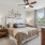 Bedroom with ceiling fan and natural light 